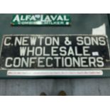 A VINTAGE 'C NEWTON & sONS WHOLESALE CONFECTIONERS' SIGN FROM A STREET IN NORTHWICH