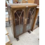 AN OAK CHINA CABINET WITH TWO GLAZED DOORS
