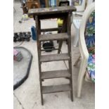 A SET OF VINTAGE WOODEN STEP LADDERS