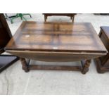 A HEAVY OAK COFFEE TABLE WITH FOUR DROP LEAVES