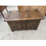 AN OAK BEDDING CHEST WITH CARVED PANELS