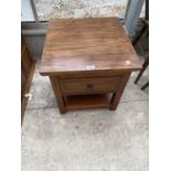AN INDONESIAN WOOD OCCASIONAL TABLE WITH ONE DRAWER