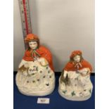 A 19TH CENTURY LITTLE RED RIDING HOOD BISQUE FIGURES, ONE FIGURE SMALLER THAN THE OTHER. 21 & 17 CM