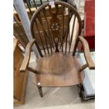 AN OAK WHEELBACK CARVER DINING CHAIR