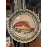 A STUDIO POTTERY CHARGER WITH A STYALISED FISH