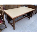 A FORMICA TOPPED TABLE ON MAHOGANY SUPPORTS