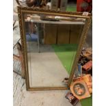 A GILT FRAMED MIRROR