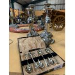 FOUR SILVER PLATED CANDLE STICKS, A PEPPER POT AND SIX TEA SPOONS IN A CASE