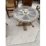 A SHIP'S WHEEL COFFEE TABLE WITH GLASS TOP