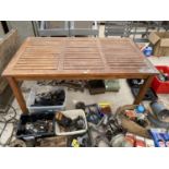 A SLATTED TEAK GARDEN TABLE