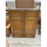 A SCUMBLED PINE CABINET WITH TWO DOORS