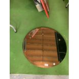 A LARGE ROUND BEVELLED EDGE MIRROR