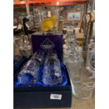 A LARGE QUANTITY OF CUT GLASS TO INCLUDE DECANTERS AND GLASSES