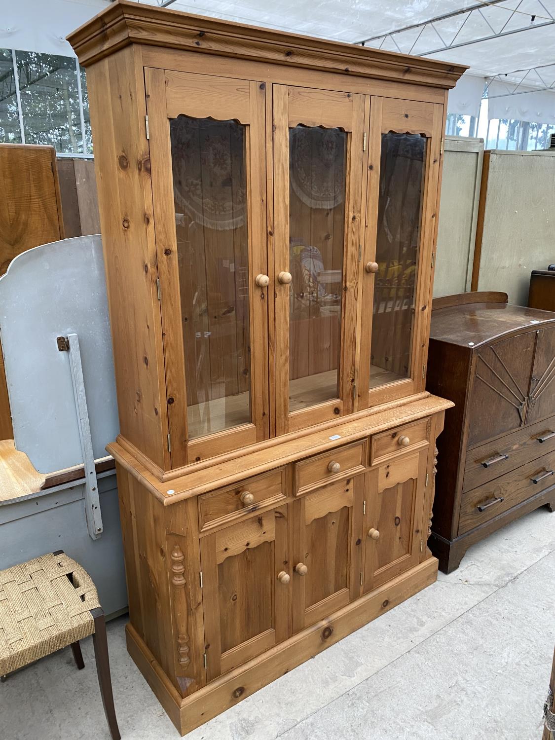 A PINE CABINET WITH THREE DOORS, THREE DRAWERS AND THREE UPPER GLAZED DOORS