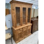 A PINE CABINET WITH THREE DOORS, THREE DRAWERS AND THREE UPPER GLAZED DOORS