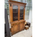 A VICTORIAN WALNUT BOOKCASE WITH TWO LOWER DOORS AND DRAWERS AND TWO UPPER GLAZED DOORS