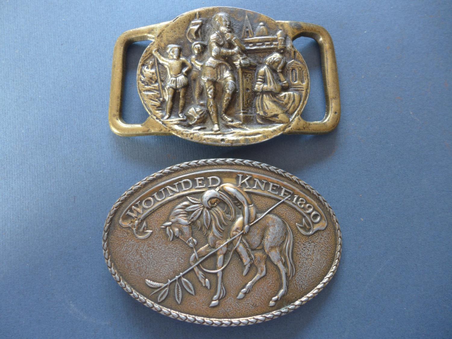 A WOUNDED KNEE BELT BUCKLE AND ONE OTHER