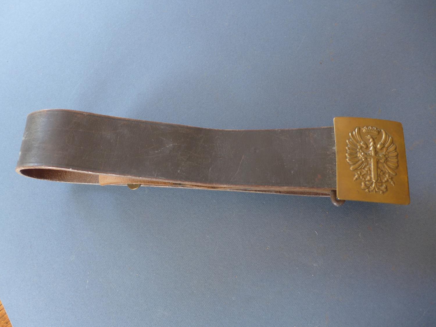 A MILITARY LEATHER BELT AND BUCKLE