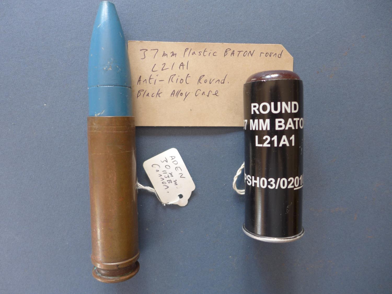 A 37 MM PLASTIC BATON ROUND AND AN ADEN 30 MM CANON ROUND