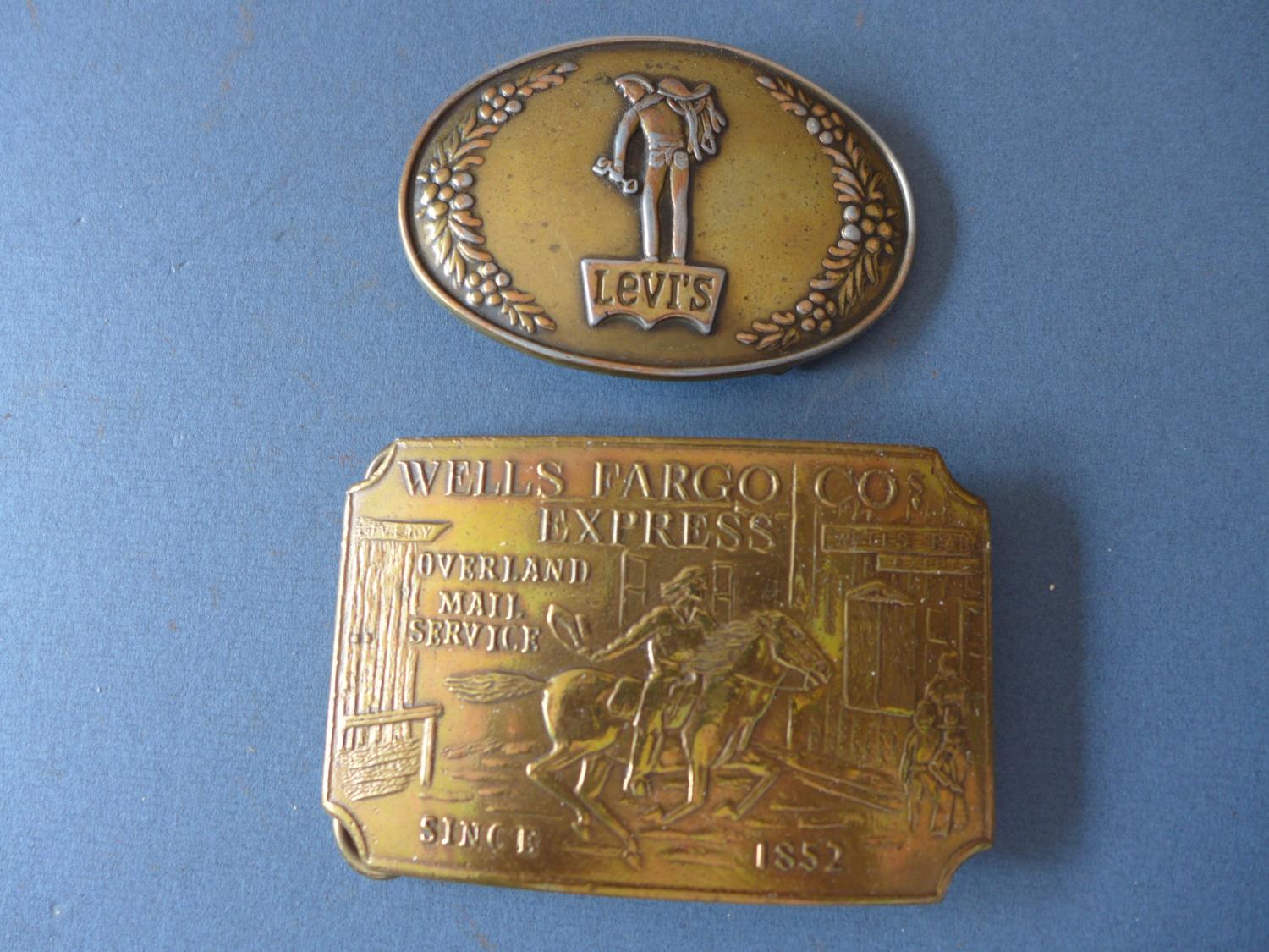 A WELLS FARGO BELT BUCKLE, MARKED TIFFANY, NEW YORK AND A LEVI'S BELT BUCKLE