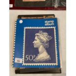 A STAMP ALBUM CONTAINING A LARGE QUANTITY OF STAMPS
