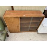 A TEAK BOOKCASE WITH ONE DOOR AND TWO SLIDING GLASS DOORS