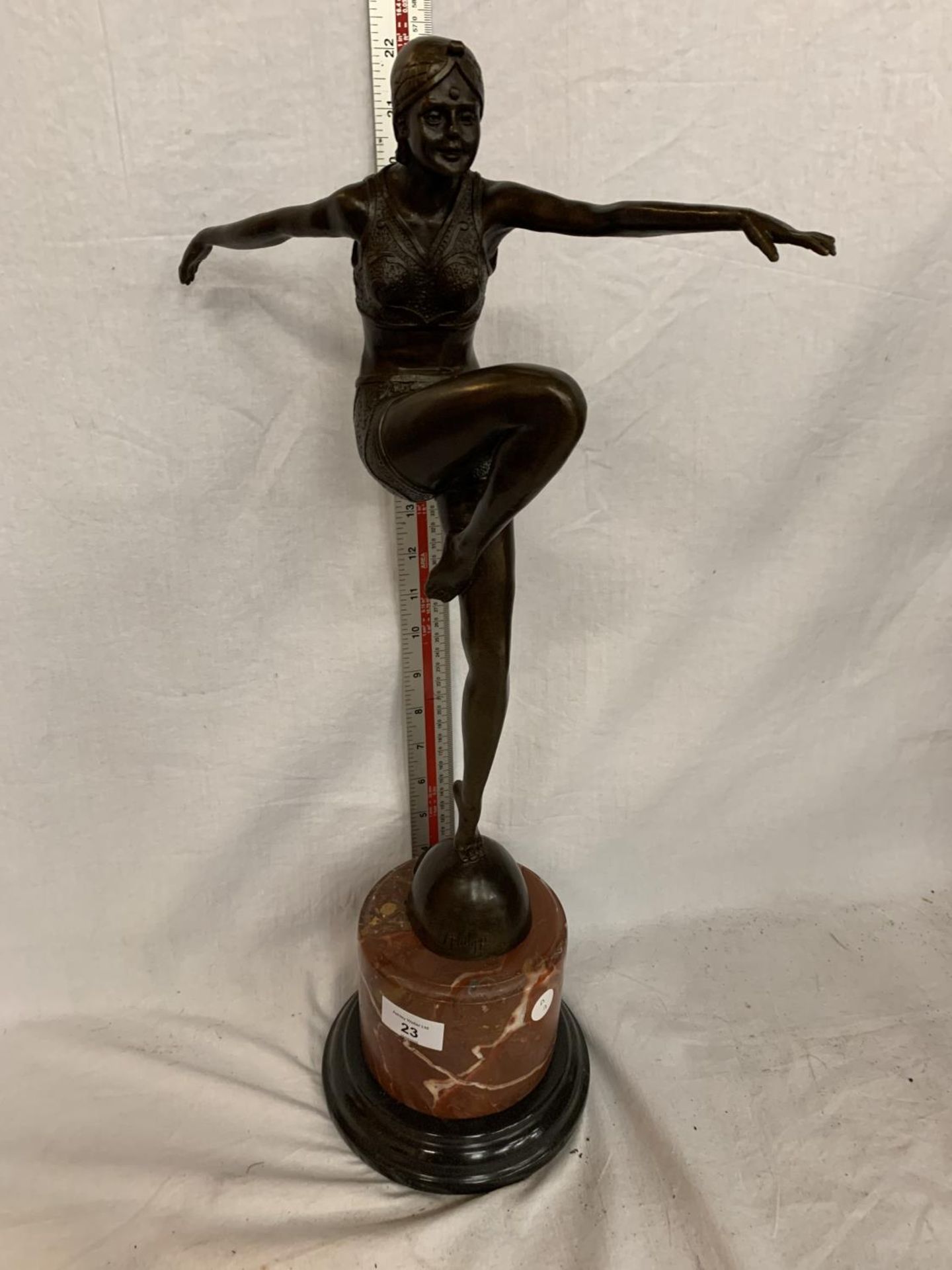 AN ART DECO STYLE BRONZE DANCING LADY ARMS OUT FIGURE ON A MARBLE BASE 52CM