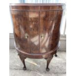 A MAHOGANY DEMI LUNE CABINET WITH TWO DOORS
