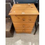 A PINE BEDSIDE CHEST OF THREE DRAWERS