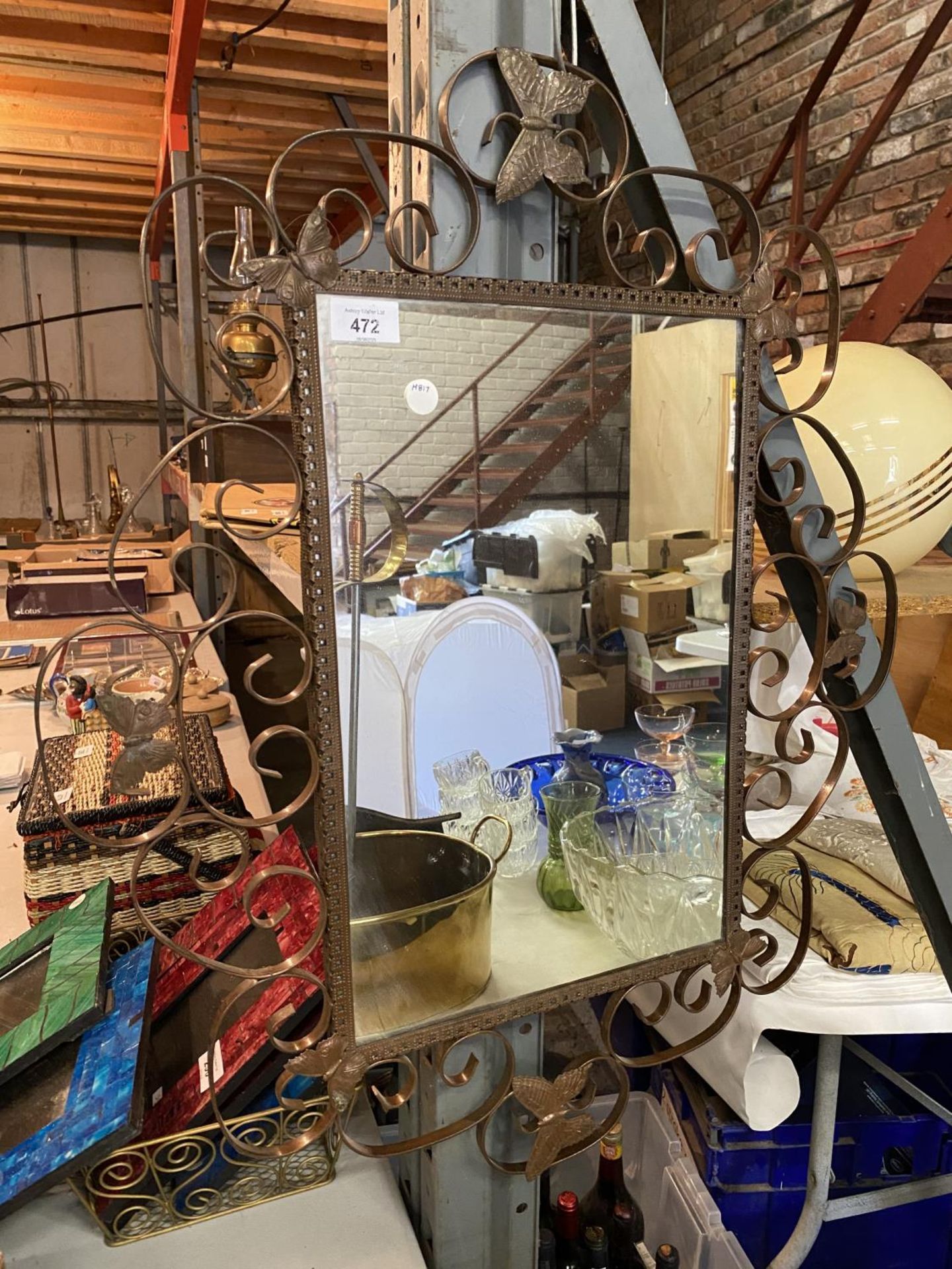 A LARGE DECORATIVE METAL FRAMED MIRROR DEPICTING BUTTERFLIES