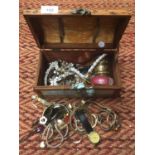A WOODEN BOX CONTAINING COSTUME JEWELLERY