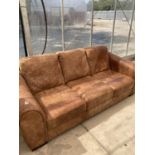 A BROWN LEATHER THREE SEATER SOFA