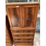 A CHARLES BARR MAHOGANY COCKTAIL CABINET WITH TWO DOORS AND FOUR DRAWERS