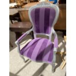 A GREY ARMCHAIR WITH PURPLE UPHOLSTERY