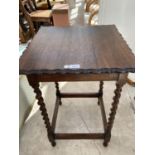 AN OAK SIDE TABLE WITH PIE CRUST EDGE AND BARLEY TWIST SUPPORTS