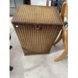 A LLOYD LOOM STYLE LINEN BASKET