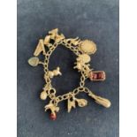 A SILVER CHARM BRACELET WITH SEVENTEEN CHARMS