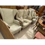 A WING BACK SOFA AND TWO ARMCHAIRS
