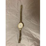 A VINTAGE LADIES WRISTWATCH, OVAL WHITE FACE SET IN A MOTHER OF PEARL MOUNT