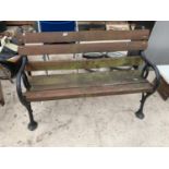 A VERY HEAVY WOODEN BENCH WITH CAST IRON ENDS