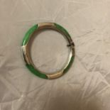 A JADE AND WHITE METAL BANGLE