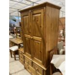 A PINE WARDROBE WITH TWO DOORS AND THREE DRAWERS