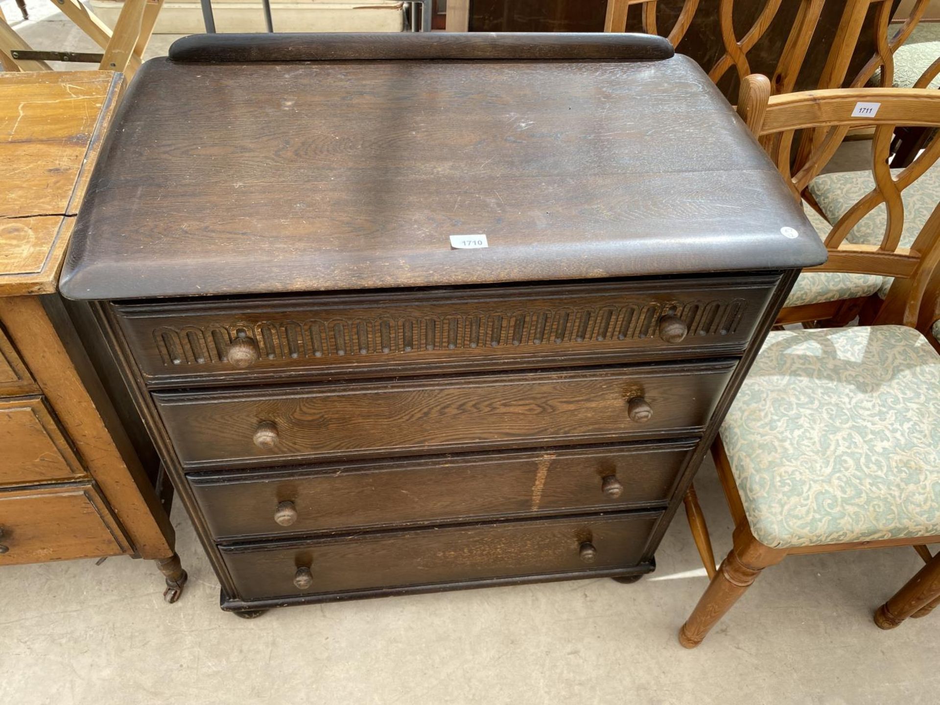 A PRIORY STYLE OAK CHEST OF FOUR DRAWERS