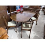 AN EXTENDING MAHOGANY DINING TABLE AND SIX CHAIRS