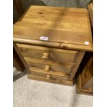 A LINE BEDSIDE CHEST OF THREE DRAWERS