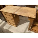 A PINE DESK WITH FOUR DRAWERS