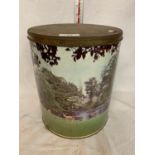 A VINTAGE LARGE CIRCULAR LIDDED TIN WITH DEERS NEAR A LAKE SCENE