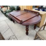 A MAHOGANY EXTENDING DINING TABLE