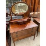 A MAHOGANY DRESSING TABLE WITH THREE DRAWERS AND UPPER OVAL BEVEL EDGE MIRROR