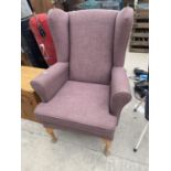 A VINTAGE WING BACK ARMCHAIR